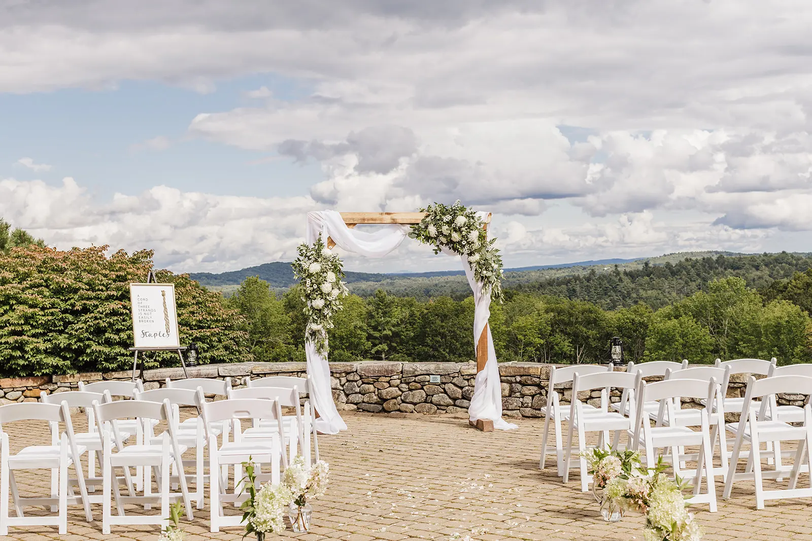 Outdoor ceremony set-up on the stone terrace with sweeping hill views