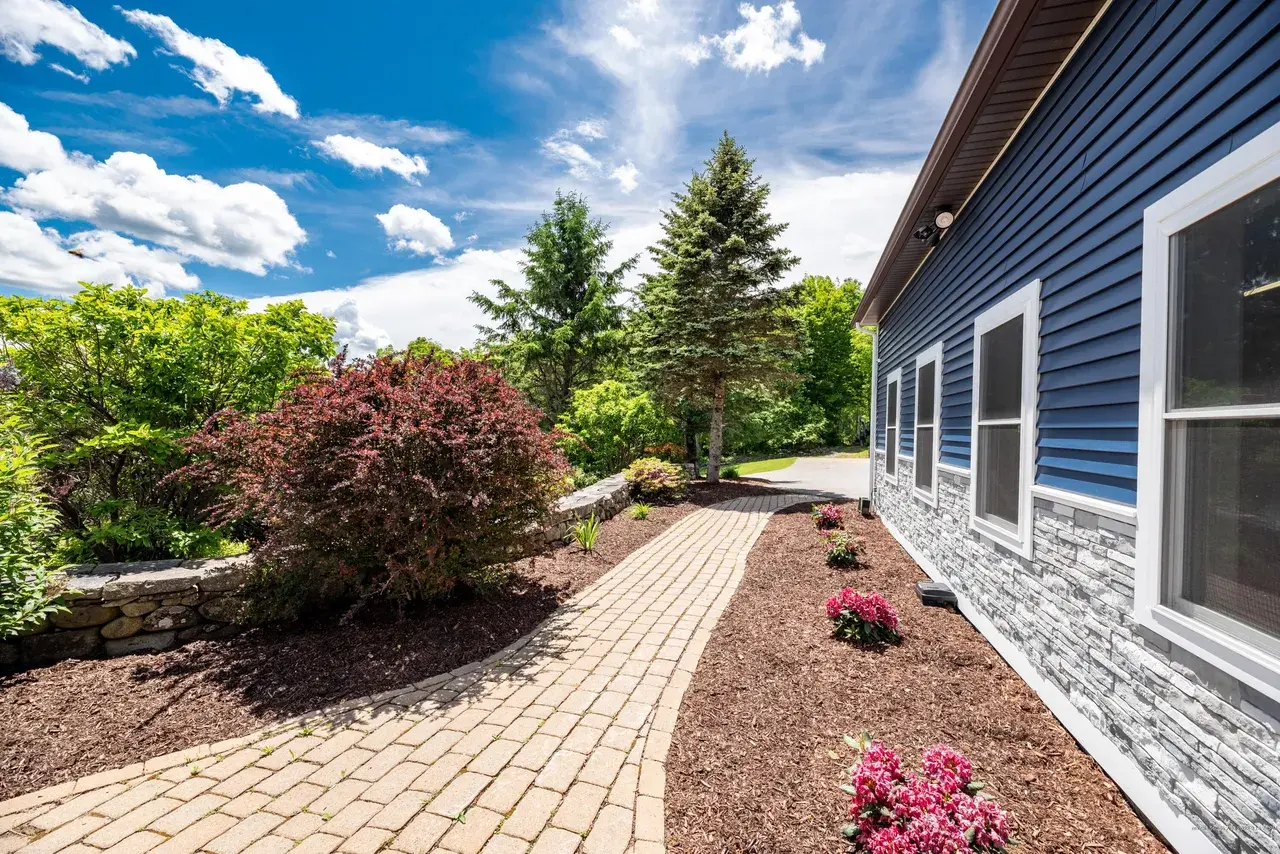 Paver walkway and plantings alongside the estate