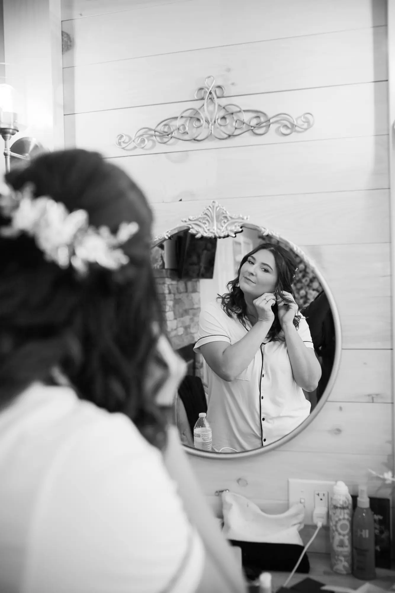 A bride getting ready in the bridal suite mirror