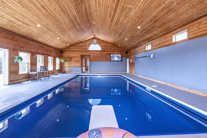 The heated indoor pool under a vaulted wood ceiling